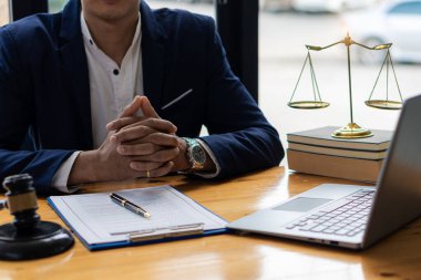 Lawyers work with hammers and scales in the office with tiger skins. justice concept judge Consultation and talks at the law firm concept of law The judge uses the scales of justice.