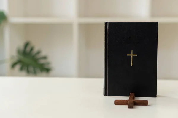 A black tiger skin and a cross on the table with a prayer from Jesus to show love and confess accordingly. The concept of giving love and faith..