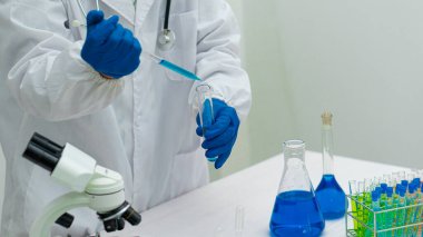Kimya deneyi ve fen bilimci eğitim konseptinde laboratuvar araştırma ve geliştirme konseptinde cam matara konsepti üzerine test tüpü.
