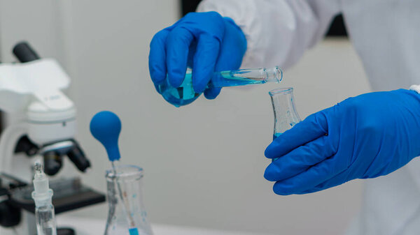 chemistry experiment and test tube in hand in science class on table Scientist education concept with glass flask in laboratory research and development concept
