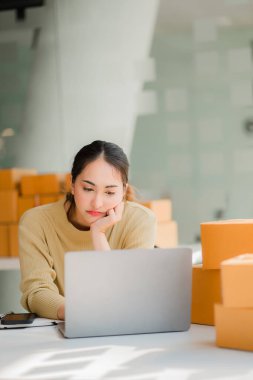 Bir KOBİ iş fikri başlatın, girişimci, genç Asyalı kadın, evden çalışan küçük işletme. Paketleme ve Nakliye serbest konsepti Dizüstü bilgisayarlarda çevrimiçi alışveriş 