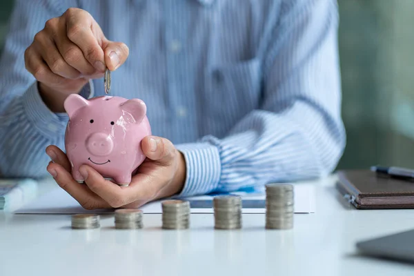 Businessman Holds Piggy Bank Puts Coins Savings Business Investments Business — ストック写真