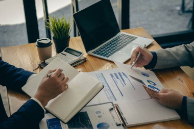 Business Consulting meetings to work and brainstorm new business projects and discuss financial data and graph reports. teamwork meeting concept