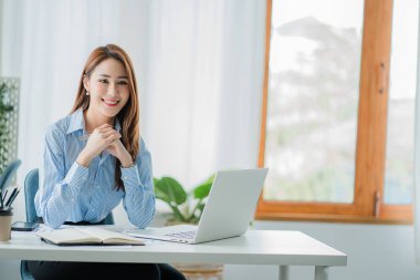 Asyalı iş kadını, matematik, vergi, muhasebe, istatistiksel raporlar ve analitik araştırma fikirlerinden para kazanmak için dizüstü bilgisayarını kullanıyor. Modern ofis gayrimenkul yatırım bilgileri