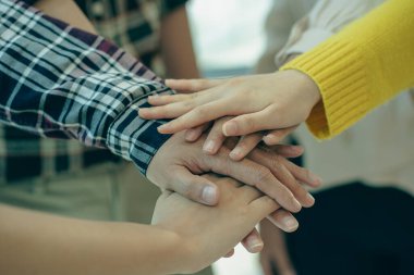 Young modern businesspeople shaking hands, feeling the power of working together. or celebrate the start of a new project in a modern office meeting. teamwork support concept