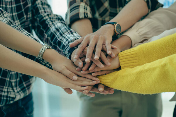 Young modern businesspeople shaking hands, feeling the power of working together. or celebrate the start of a new project in a modern office meeting. teamwork support concept