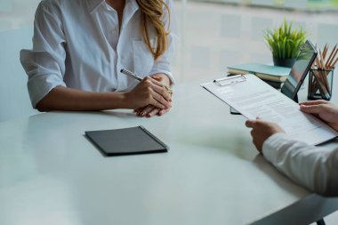 An HR manager interviews one of the candidates who posted Select Focus. A male job seeker holding a resume congratulating a successful successful good interview concept position.