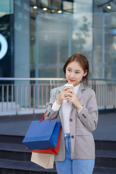 一个快乐的亚洲女人站在购物中心前 是的持购物袋的亚洲妇女 持五颜六色纸袋的妇女概念购物台和垂直购物台 — 图库照片