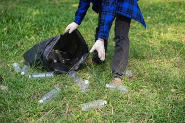 Genç bir adam plastik şişeleri ve siyah poşetleri topluyor ve onları geri dönüşüm için toplayanlara satmak üzere biraraya getiriyor. Atık ayırma ve çevre koruma kavramı