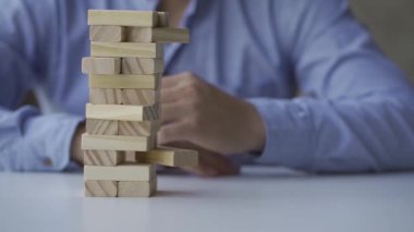 Bir iş adamının tahta bir bloğu çekmesi tehlikeli bir proje başarısızlığı riskine karşı alternatif bir iş kulesi inşa etmekte başarısız oldu..