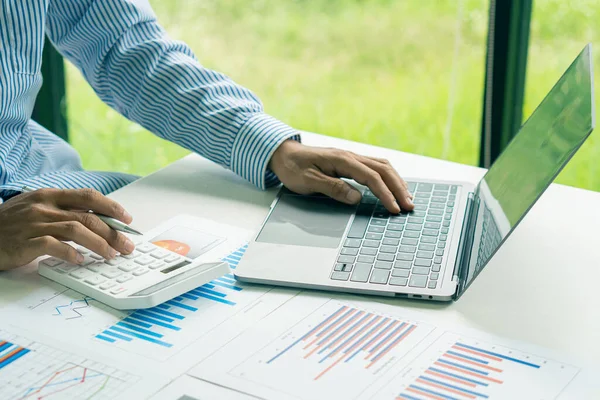 businessman hands working on laptop computer data analysis financial chart review online work concept