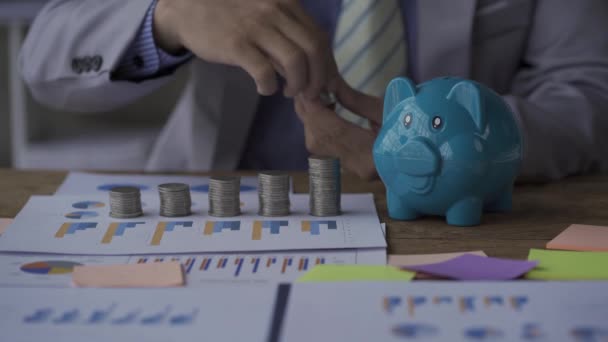 Piggy Bank Business Table Pile Coins Concept One Hand Puts — Vídeos de Stock