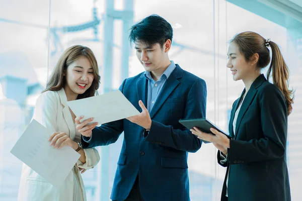 small group of young people at a business meeting a team in a modern office planning of work design and brainstorming ideas Hands of a businessman working on documents and laptops