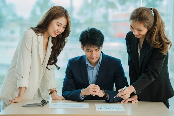 small group of young people at a business meeting a team in a modern office planning of work design and brainstorming ideas Hands of a businessman working on documents and laptops
