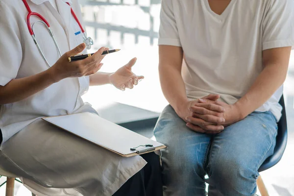 Doctors talk to patients in the clinic office. The focus is on the stethoscope and the patient consults and diagnoses, sits and talks. at the table near the window in hospital medical concept