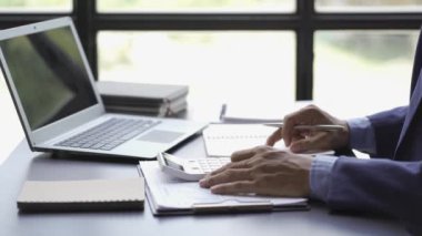 Businessman working with charts and graphs at desk to analyze financial data and show company development. 4k video.