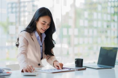 Analyzing data figures to plan business strategies Young Asian businesswoman as a business executive Founder and Managing Startup female business leader Startup business idea