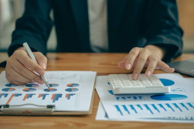 The company's accountant analyzes the expenses on the business desk. financial reporting accountant computer with graph chart business idea Finance and Accounting