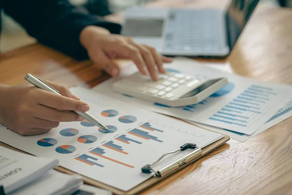 The company\'s accountant analyzes the expenses on the business desk. financial reporting accountant computer with graph chart business idea Finance and Accounting