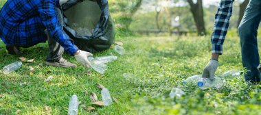 volunteers collect plastic bottles in garbage bags ecology natural pollution garbage care charity volunteer community environment young sincerity Recycling that can be sold as family income