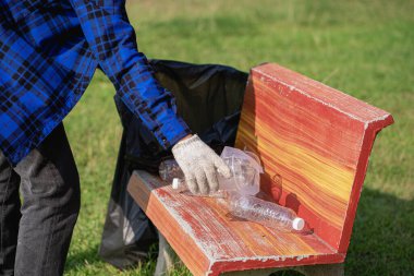 volunteers collect plastic bottles in garbage bags ecology natural pollution garbage care charity volunteer community environment young sincerity Recycling that can be sold as family income