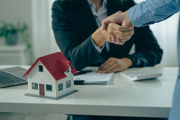 The sales agent offers the customer a home purchase contract to purchase the property, a handshake between the sales agent and the landlord when signing a home purchase or rental contact.
