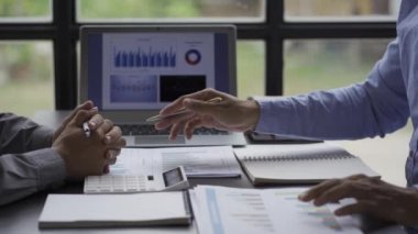2 business people looking at financial charts in notebooks cheerful man analyzingWork in the office Gadgets and documents with graphs and data 4k video