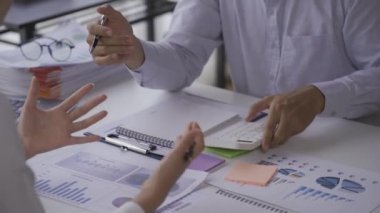 Businessmen, 2 men and women look at financial analysis charts. work in the office and documents with graphs and data, 4k video