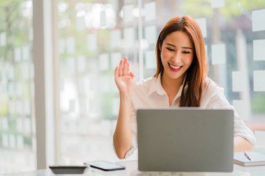 beautiful asian business woman Millennial professional female financial analyst working on financial charts and chart data with laptop in the office.