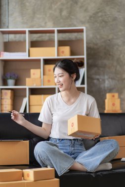 Small Business Startup SME Owners Asian Women Also Check Online Orders Laptops and sales of work items with girl boxes. Work independently at home, online SME business, small and medium enterprises