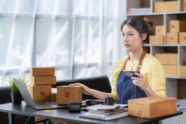 Small Business Startup SME Owners Asian Women Also Check Online Orders Laptops and sales of work items with girl boxes. Work independently at home, online SME business, small and medium enterprises