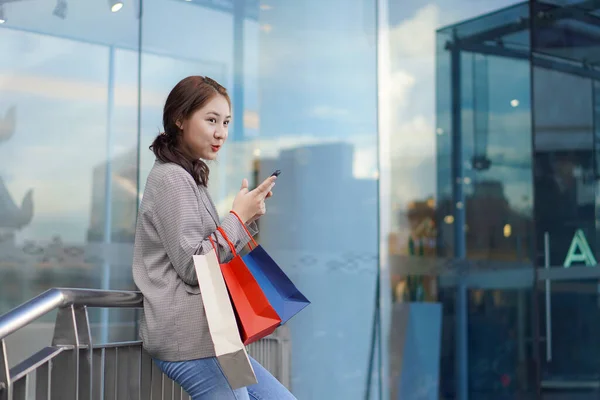 Smiling Asian Woman Colored Shopping Bags Shopping Mall Background Looking — 图库照片