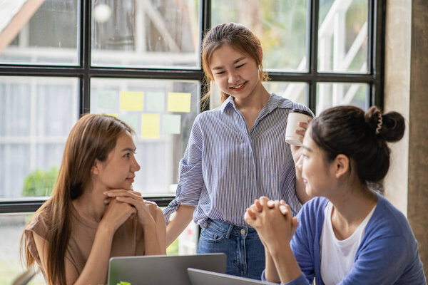 a group of successful business people in the conference room Asia Youth Team Startup Ideas: Meet young entrepreneurs brainstorm business plans and share ideas in a workshop.