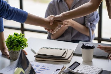 Businessmen shake hands after reaching an agreement and to expand business investment networks and create project development or employment and agreement ideas.