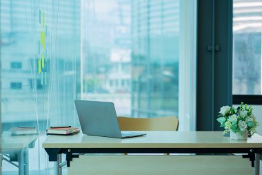 business office with financial documents and laptop on desk