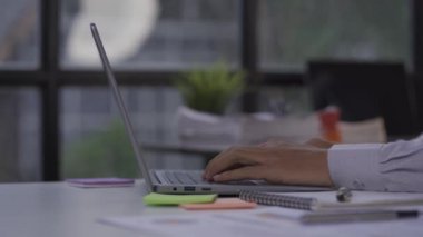 Finance and investment, accounting, tax calculations, company financial reports. Close-up of businessman accountant calculating on calculator and texting on laptop about financial reports