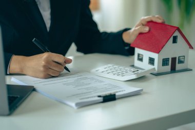 Model homes with real estate agents and home purchase contracts, insurance or real estate loans in the sales office.