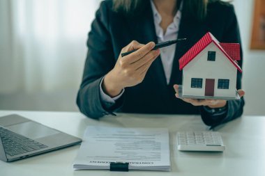 Model homes with real estate agents and home purchase contracts, insurance or real estate loans in the sales office.