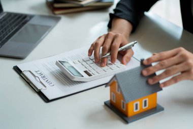 Model homes with real estate agents and home purchase contracts, insurance or real estate loans in the sales office.