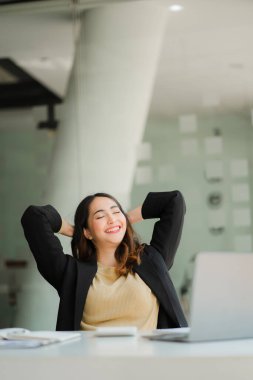 Asian female accountant relaxing on a chair to relax from work