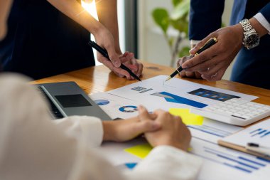 Asian business advisor meeting to analyze and discuss the situation of financial reports in the meeting room for financial investment advisors, accounting concepts.