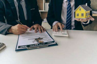 A sales representative is discussing the details before the customer agrees to sign a contract. by explaining the details and terms and conditions of the rental real estate concept
