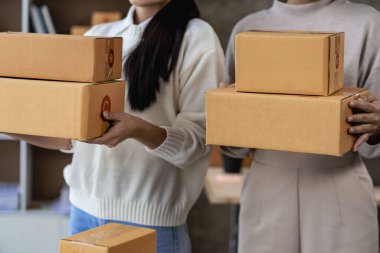 Online store, small business owner, box operator, e-commerce, check website retail order using laptop, prepare parcels, deliver on table. SME business idea.