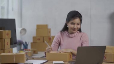 Asian woman working with laptop keyboard check online order check goods stock delivery parcel courier postage asian woman start small sme business at home