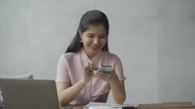 Online business Asian female accountant working from home on laptop in meeting