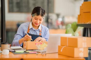 small entrepreneur start home business by arranging goods with yellow parcel box sme business idea
