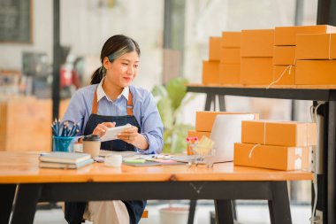 small entrepreneur start home business by arranging goods with yellow parcel box sme business idea