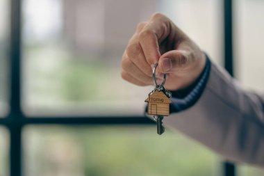 house sales representative holding keys by businessman The agent gives the key to the customer. home buying real estate ideas