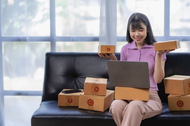 Starting a Small Business, SME Owners, Female Entrepreneurs Use your laptop or smartphone to accept and check online orders to prepare sales box packs for SME customers online business ideas.