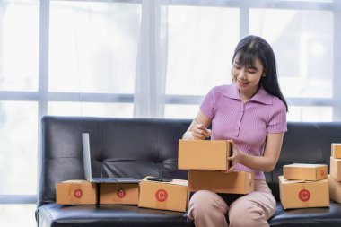 Starting a Small Business, SME Owners, Female Entrepreneurs Use your laptop or smartphone to accept and check online orders to prepare sales box packs for SME customers online business ideas.